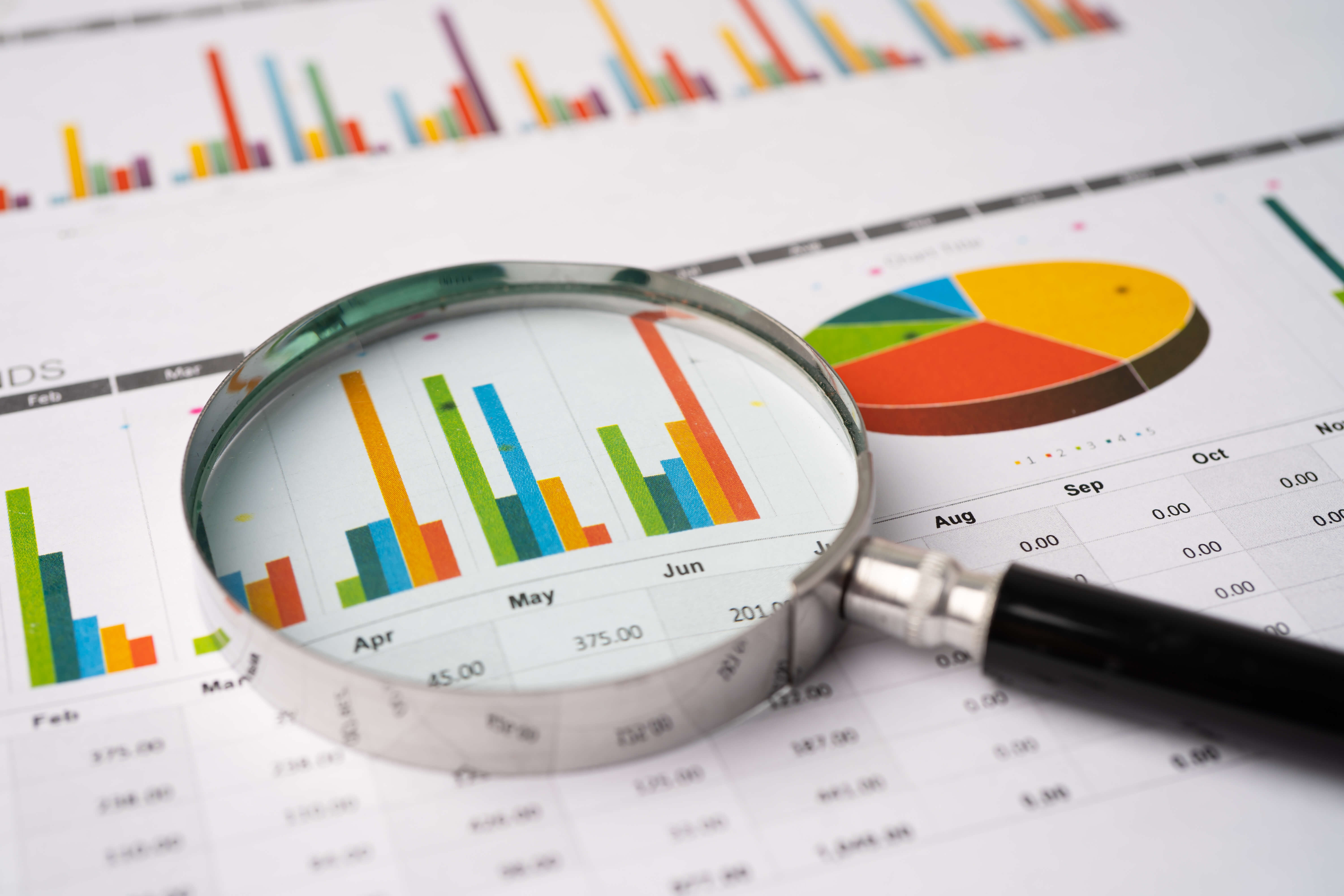 Magnifying glass on charts graphs paper. Financial development, Banking Account, Statistics, Investment Analytic research data economy, Stock exchange trading, Business office company meeting concept.
